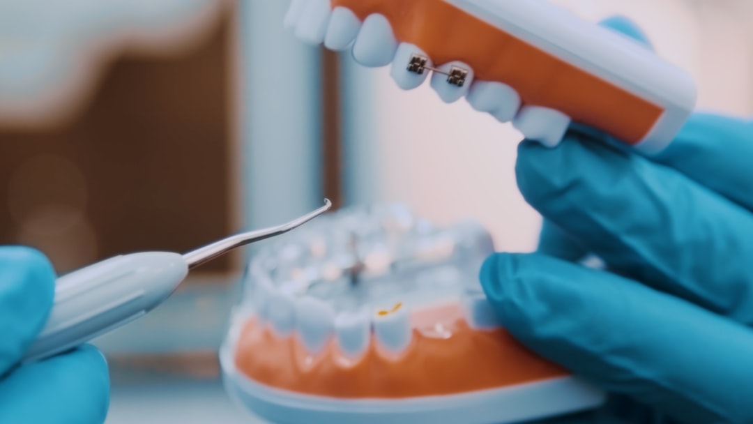 a-person-in-blue-gloves-holding-a-toothbrush-aeg3jig0xsq